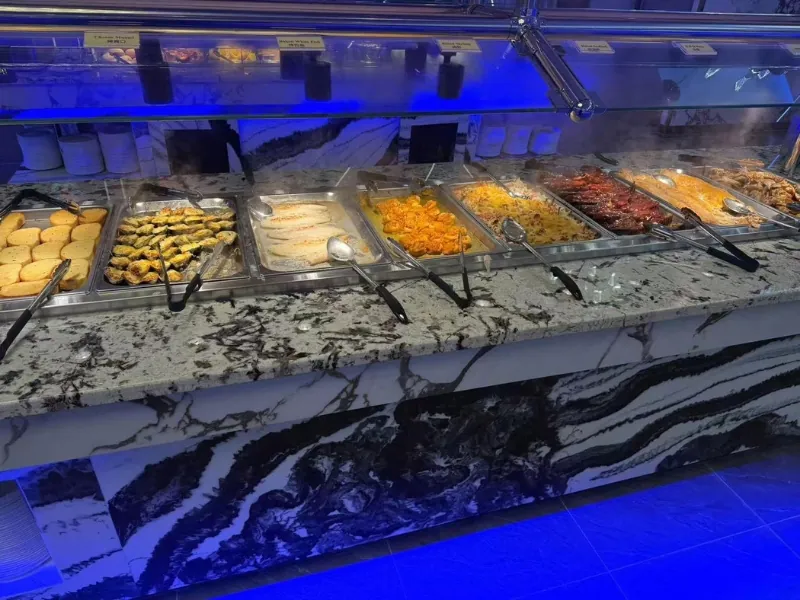 Asian hot dishes station with dumplings, seafood, and meats at King Buffet, a Buffet Restaurant in Westminster.